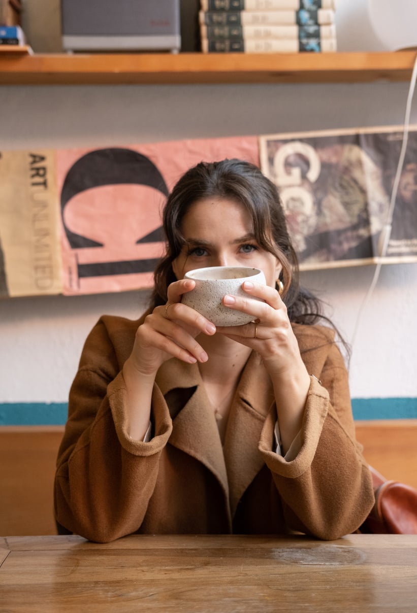 Woman Drinking Coffee in a Coffeeshop